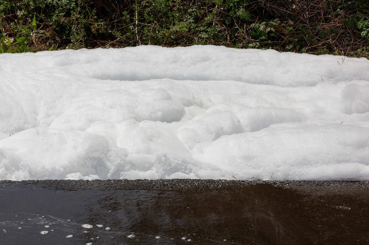 environmental hazard toxic pfos chemical fire foam floating down street firefighting chemicals